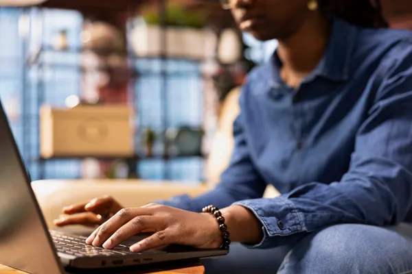 Freelancer at home using laptop to check emails displayed on screen