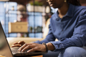 freelancer at home using laptop to check emails displayed on screen